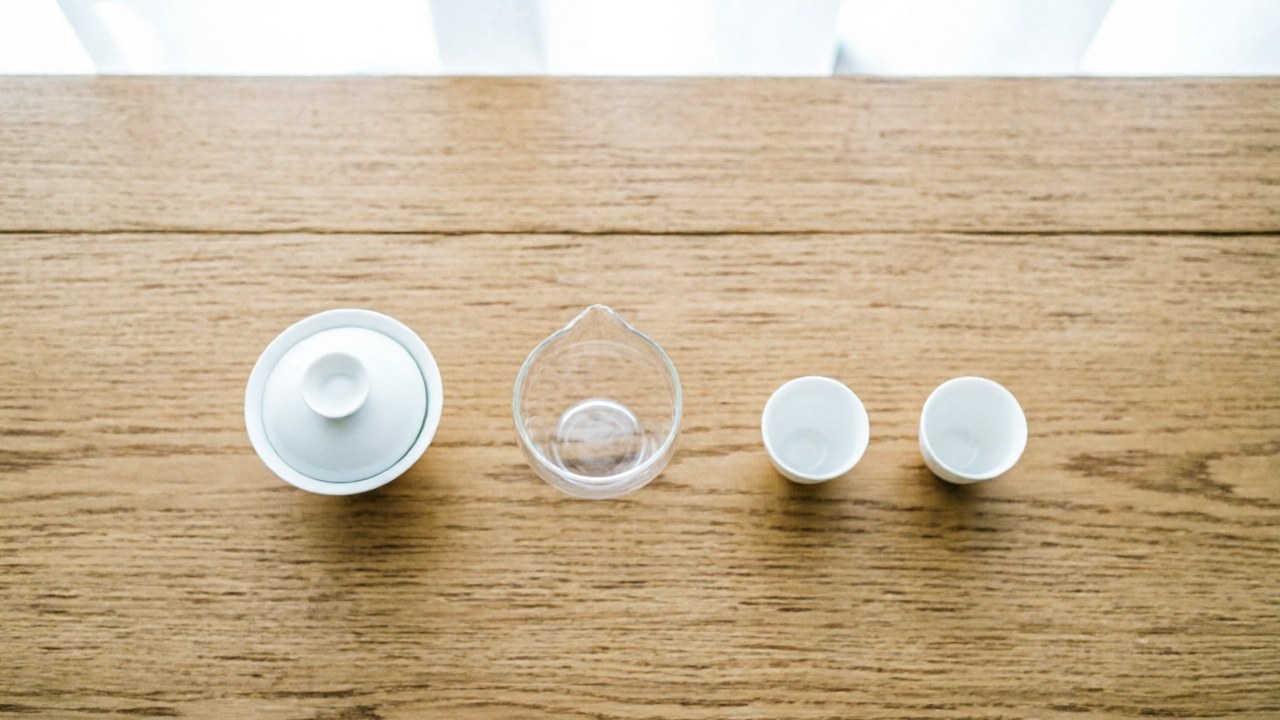 Gongfu setup with lidded bowl, glass cha hai, and two teacups